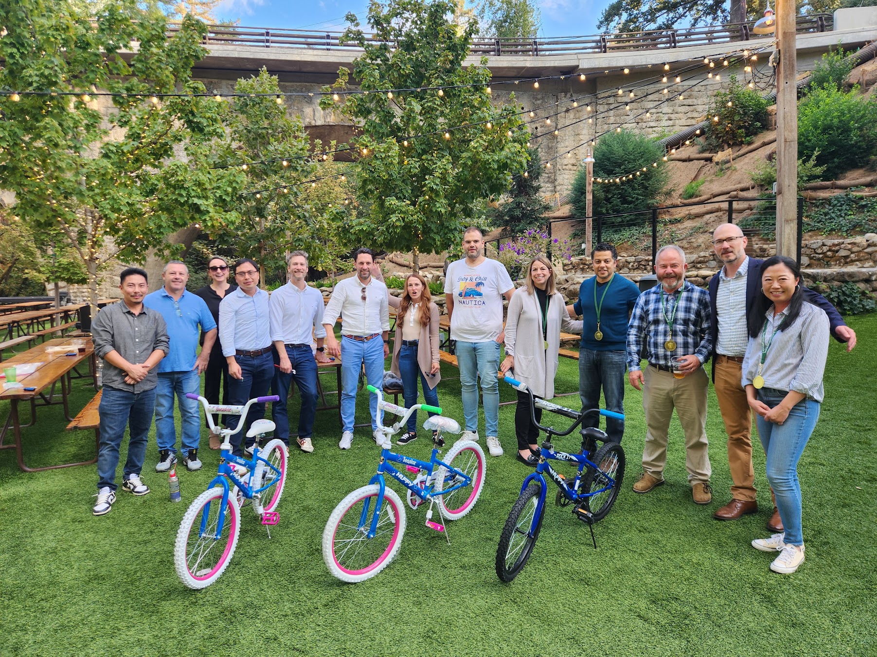 A small team posing with completed bicycles at Saratoga Springs